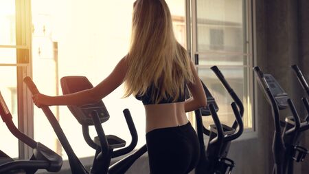 Sexy girl on treadmill in gymの写真素材