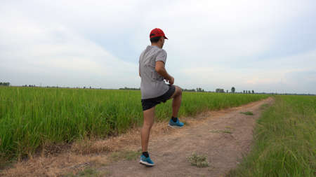 Young man runner jogging exercise healthy lifestyle in green field