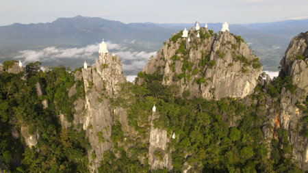 Aerial view of Wat Phra Bat Phu Pha Daeng and white pagodas on top peak in Lampang province Thailandの写真素材