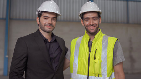 Warehouse worker and manager checking product in a large warehouse