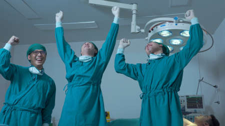 Professional medical doctor team raising hands up in hostipalの写真素材