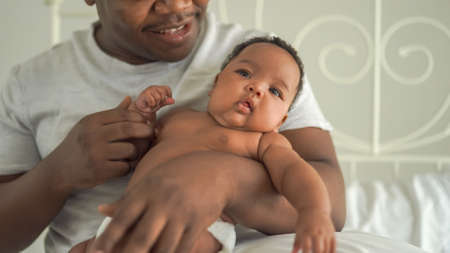 Happy African man with his little baby