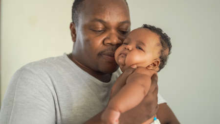 Happy African man with his little baby
