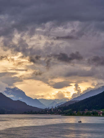 Dramatic sky and sunset lake Weissensee Austriaの写真素材