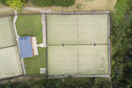An overhead view of a tennis court in the suburbs