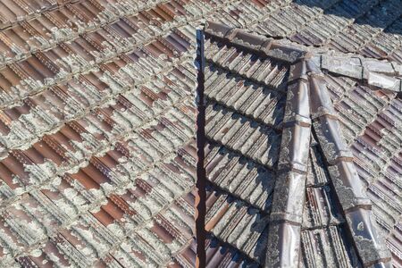 Terracotta Roof Tiles in poor condition on a houseの写真素材
