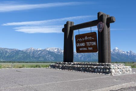 Grand Teton National Park sign with mountains in the backgroundの写真素材