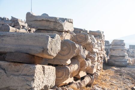 Old stone pillars lying on the ground at a building site.の写真素材