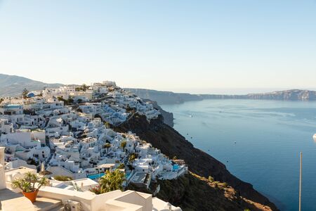 Small villages of white buildings with the ocean in the background on Santorini Island in Greece.の写真素材