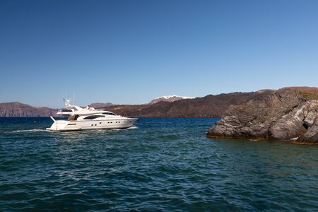 Yachts and sailing boats on the Aegean Sea in the Greek Islands near Santorini Islandの写真素材