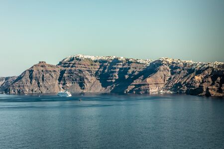 A cruise ship on the blue Aegean Sea near Santorini Island in the Greek Islandsの写真素材