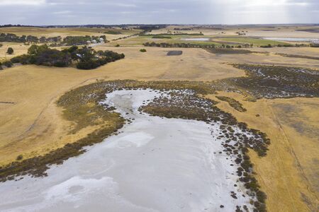 A large fresh water dam on Hindmarsh Island south of Adelaide in Australia that is dry due to drought and full of saltの写真素材