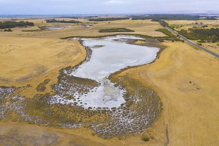A large fresh water dam on Hindmarsh Island south of Adelaide in Australia that is dry due to drought and full of saltの写真素材
