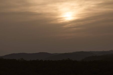 A vivid orange sunset caused by bushfire smoke in The Blue Mountains in Australiaの写真素材