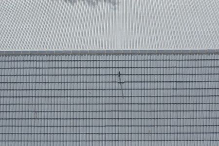 Breather pipe on a grey tiled roofの写真素材