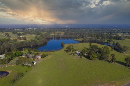 An irrigation lake on large green farmland in a rural areaの写真素材
