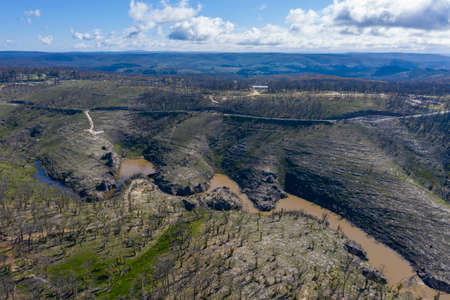 Aerial view of a water reservoir surrounded by forest regeneration after bushfires in Dargan in the Central Tablelands in regional New South Wales Australiaの写真素材