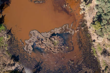 Drone aerial photograph of a polluted small overflow reservoir after severe flooding in Yarramundi...