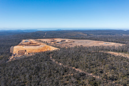 Drone aerial photograph of the construction of an industrial sand quarry in a forest affected by severe bushfireの写真素材
