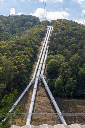 Photograph of a large hydro power station with water feeder pipes in the Snowy Mountains in New South Wales in Australiaの写真素材