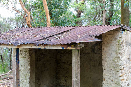 Photograph of an old brown rusty roof covered in fallen leaves on an explorers hut in The Blue Mountains in New South Wales in Australiaの写真素材