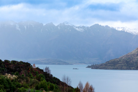 Photograph of Lake Wakatipu in Queenstown with mountains and clouds in the background on the South Island of New Zealandの写真素材