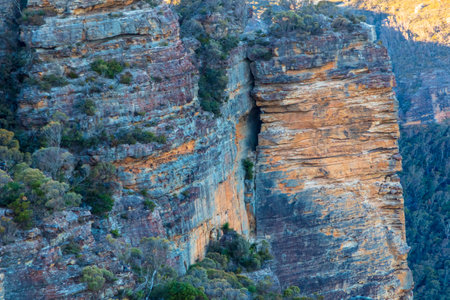 Photograph of the rugged and rocky cliff face of mountains the Megalong Valley in the Blue Mountains in New South Wales in Australiaの写真素材