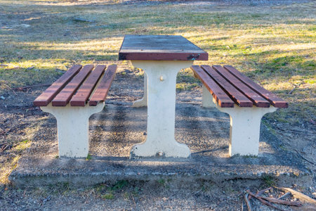 Photograph of an old picnic table and chairs in the garden near the path that leads to Cahills Lookout on the Megalong Valley in the Blue Mountains in New South Wales in Australiaの写真素材