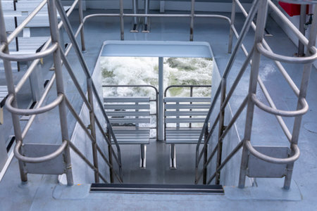 Photograph of stairs leading from the top deck on a tour boat in Milford Sound in Fiordland National...