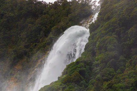 Photograph of Water Falls after very heavy rain and cold weather in Milford Sound in Fiordland National Park on the South Island of New Zealandの写真素材