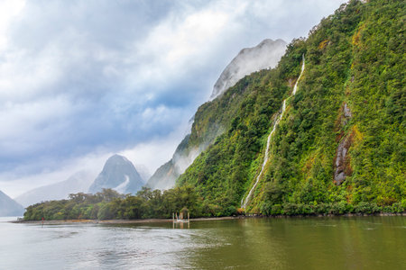 Photograph of Water Falls after very heavy rain and cold weather in Milford Sound in Fiordland National Park on the South Island of New Zealandの写真素材