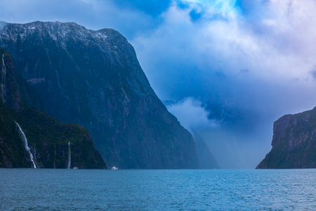 Photograph of Water Falls after very heavy rain and cold weather in Milford Sound in Fiordland National Park on the South Island of New Zealandの写真素材