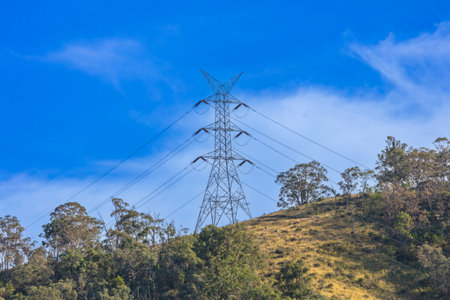Photograph of a large electricity Transmission Tower on a grassy hill against a bright blue sky in regional Australia.の写真素材