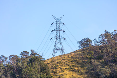 Photograph of a large steel electricity Transmission Tower on a grassy hill in regional Australia.の写真素材
