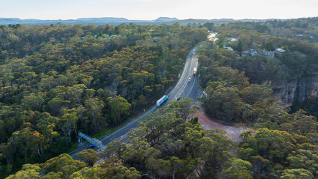 Drone aerial photograph of traffic on the Great Western Highway running through a forest near the town of Mount Victoria in the Blue Mountains in New South Wales, Australia.の写真素材