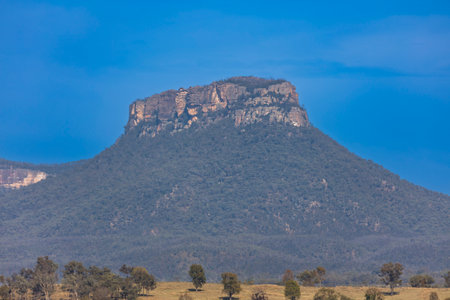 Photograph of a large flat topped cliff faced mountain on a large hill in Capertee Valley in the Central Tablelands of NSW, Australia.の写真素材