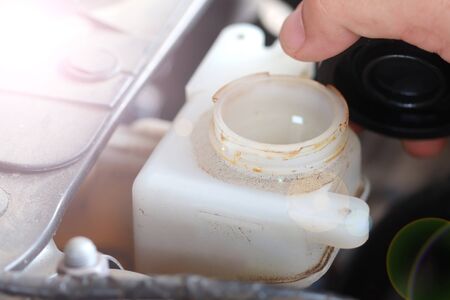 Close up brake oil tank open by driver's hand for check levelの写真素材
