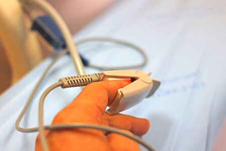 Patient's finger with Portable hand domestic cardiac finger pulse for checking blood pressure....