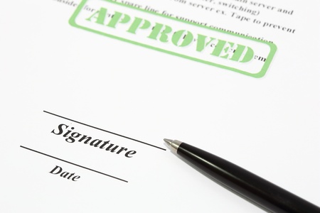 Sign name on document with black pen