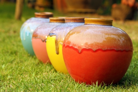 Color jars on green grassの写真素材