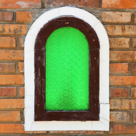Green window on the wall brickの写真素材