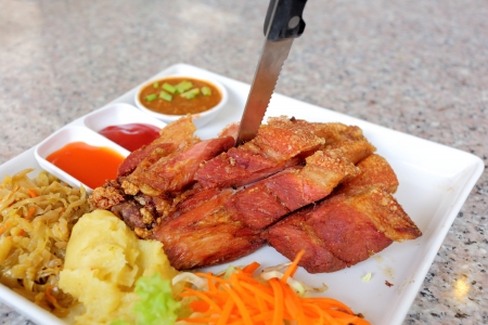 Fried pork with sauce and potatoの写真素材