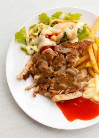 grilled pork steak with potato and saladの写真素材