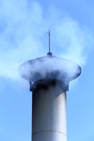 factory smokestack on blue skyの写真素材