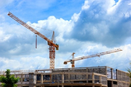 Crane working in construction on blue skyの写真素材