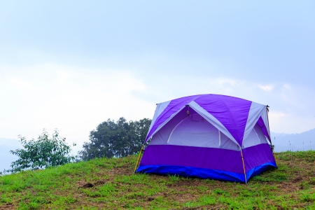 Camping tent on mountain with blue sky の写真素材