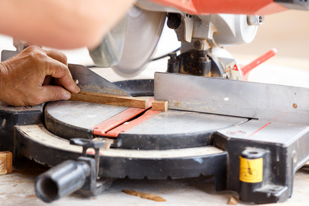 carpenter cut wood for house construction 