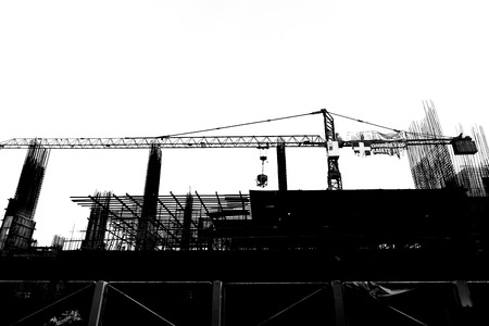 Construction site with cranes on silhouette background の写真素材