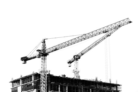 Construction site with cranes on silhouette backgroundの写真素材