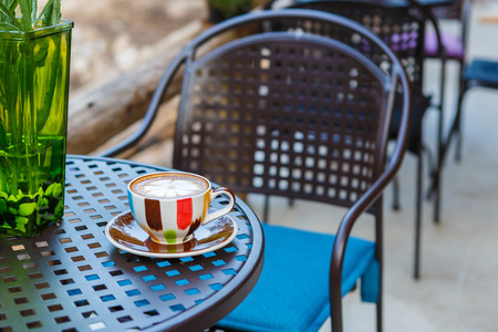 Latte coffee cup on table in cafeの写真素材